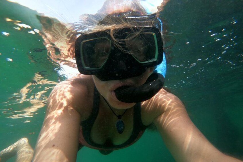 A person snorkeling underwater. 3
