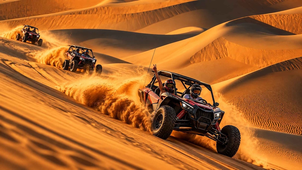 Off-road vehicles navigating a sandy dune landscape. 3