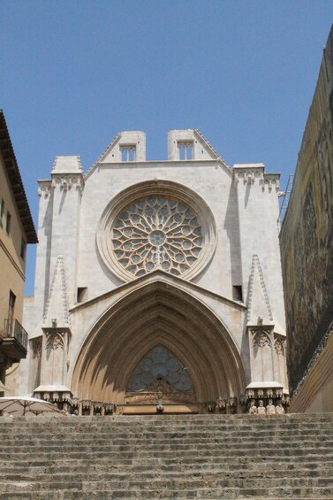 A historic cathedral with a large rose window and a pointed arch entrance. 3