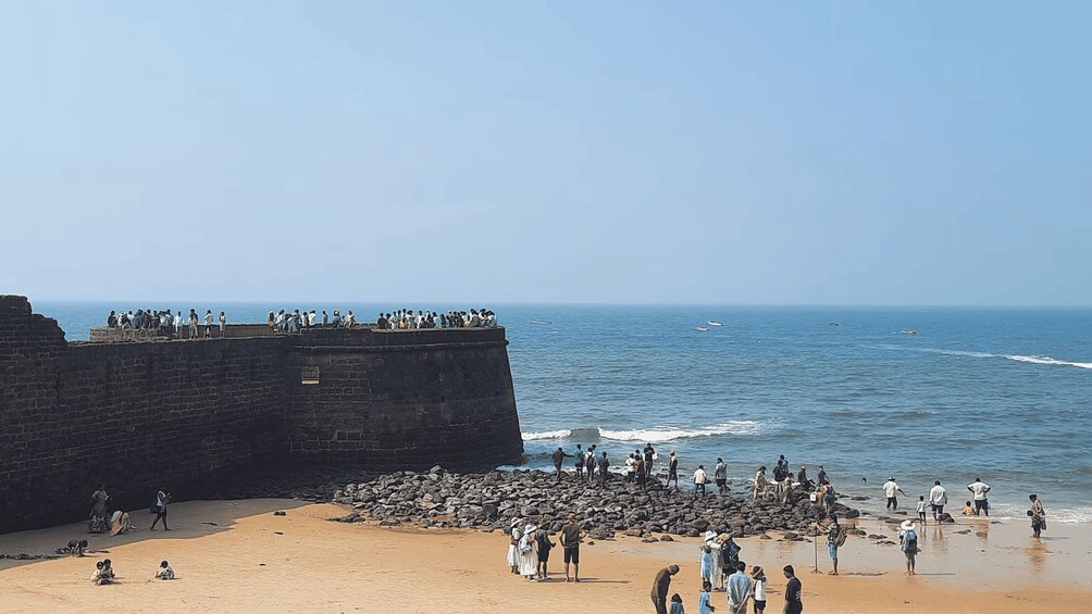 A coastal scene with a stone wall and beach. 3