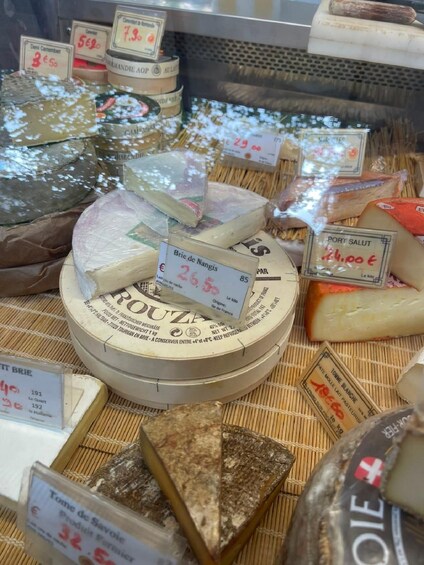 Various types of cheese with price tags. 4