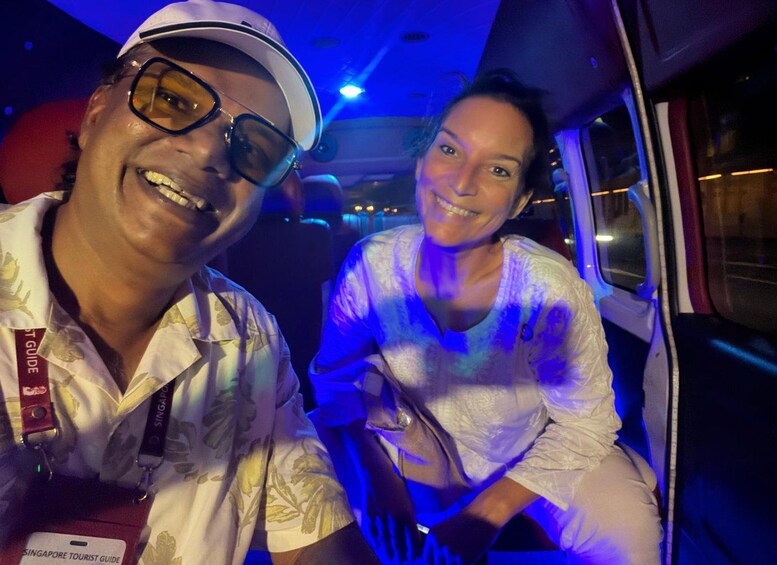 Two people inside a vehicle with a blue light in the background. 2