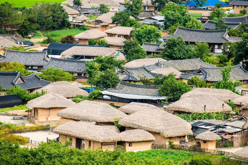 A traditional village with thatched-roof houses and tiled roofs. 3