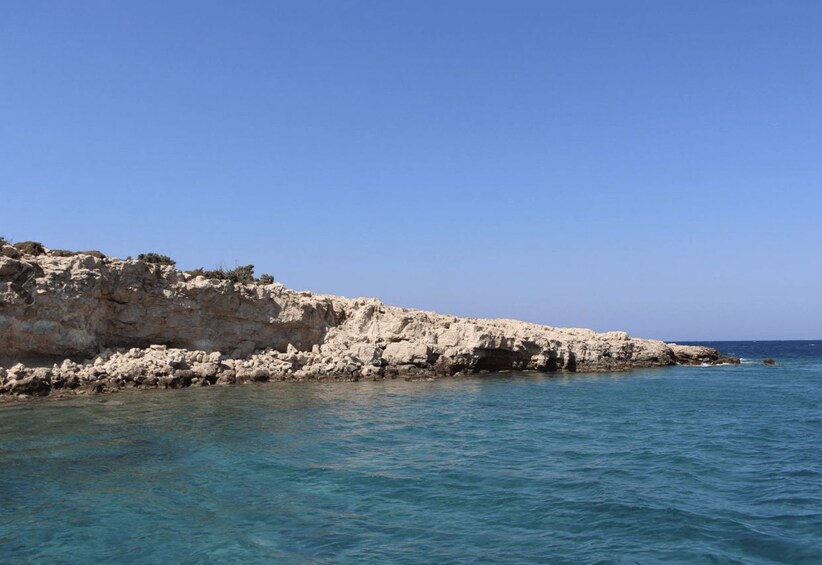 A rocky coastline with clear blue waters. 5