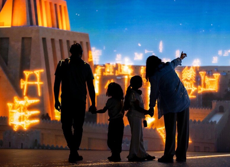 A family holding hands in front of a building with illuminated structures. 1