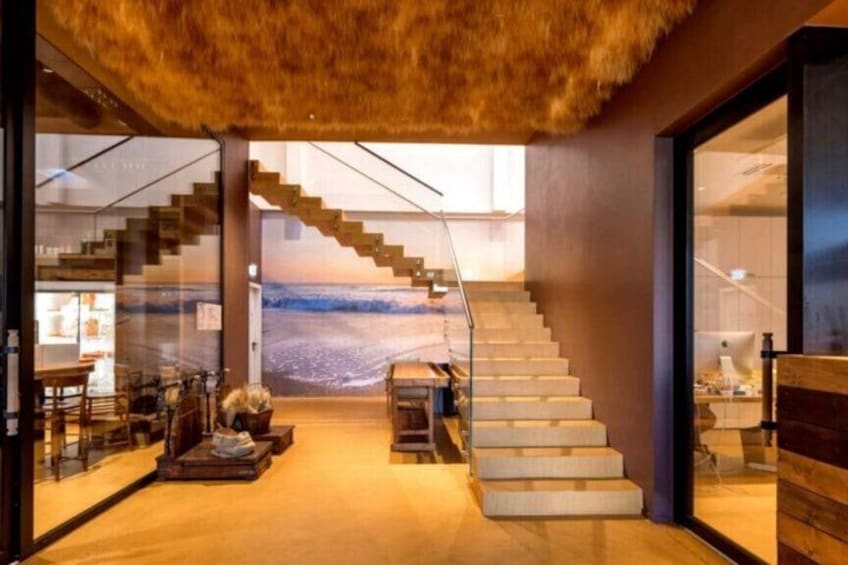 A modern interior with a staircase, glass walls, and a view of a snowy landscape. 3