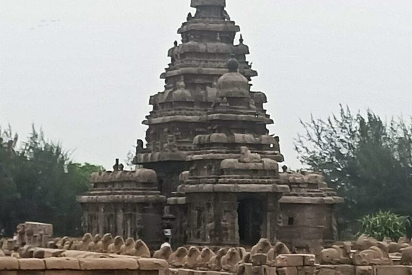 A stone temple with multiple tiers and intricate carvings. 3