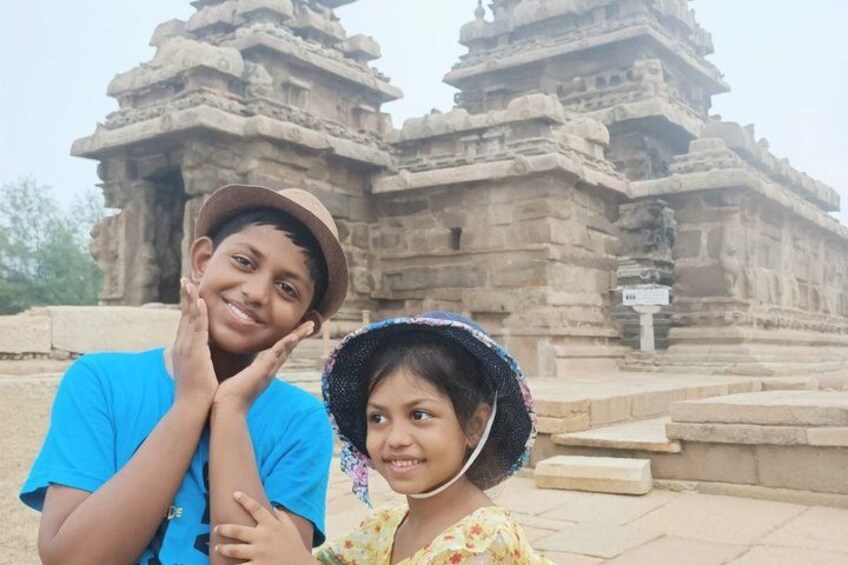 Two people in front of ancient stone structures. 4