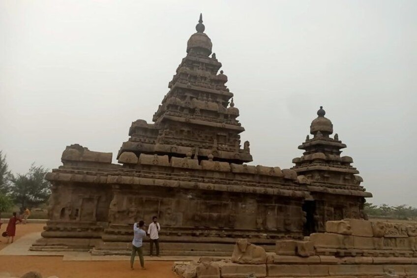 A large stone temple with multiple tiers and a central spire. 1