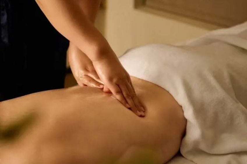 A person receiving a massage on their back. 2