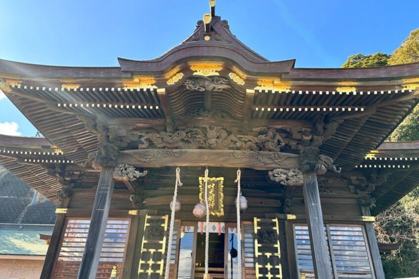 A traditional Japanese temple with ornate architecture, including a curved roof and intricate carvings. 3