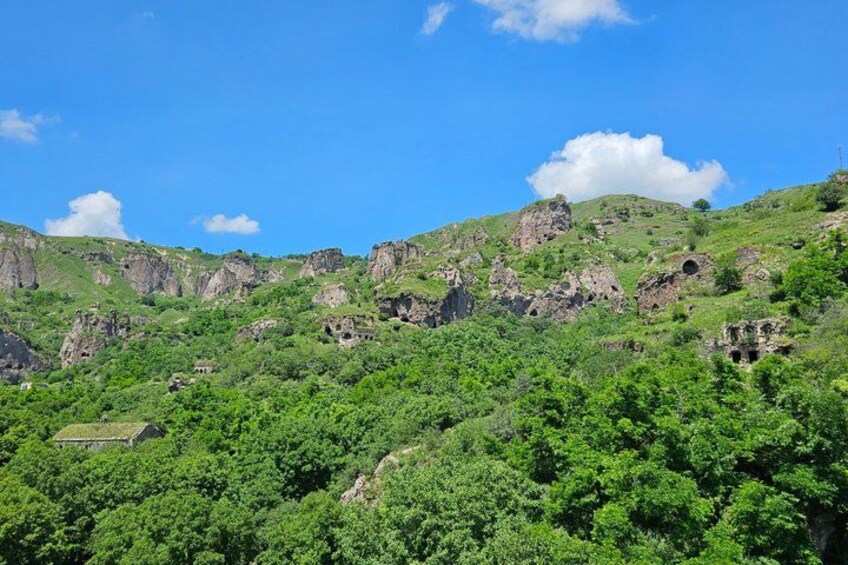 A mountainous landscape with green vegetation and rocky outcrops. 3