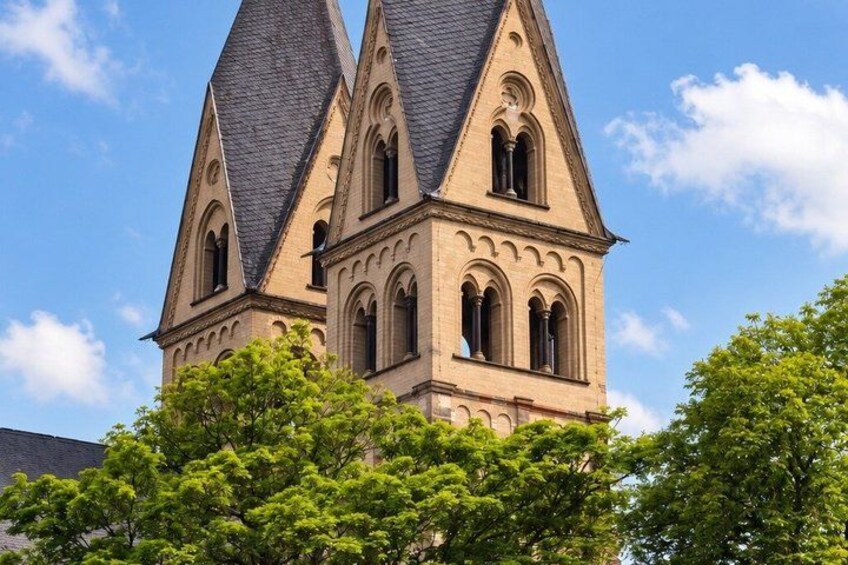 A church with two tall spires and a clock tower. 4