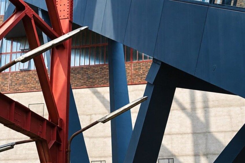A red metal structure with blue beams, likely part of a bridge or large construction. 4