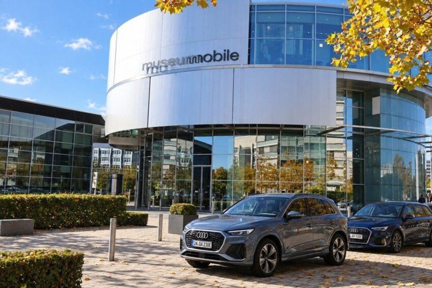 A modern building with the sign 'museummobile' and parked cars in front. 5