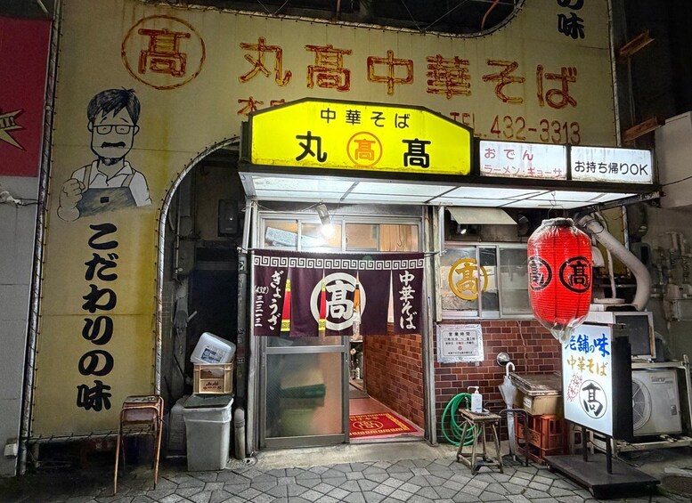 A storefront with a yellow sign and a red lantern. 3