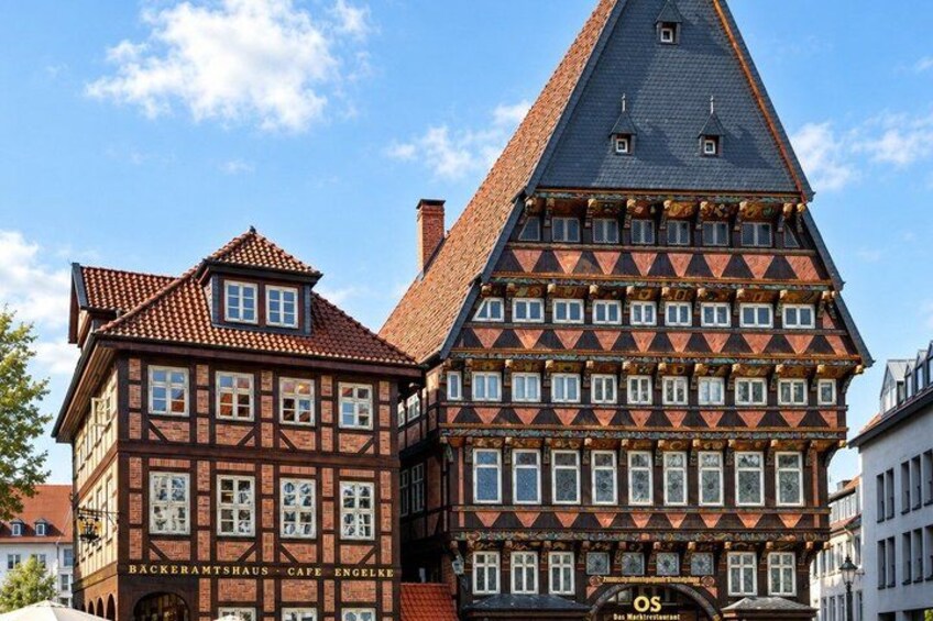 A traditional half-timbered building with a steeply pitched roof and a sign for 'Backeramshaus Cafe Engelke.' 4