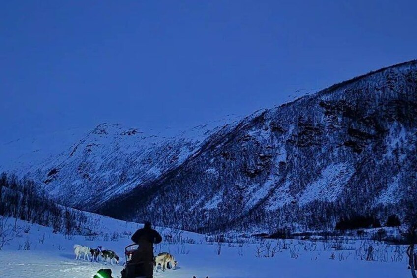 A snowy mountain landscape with a person standing in the foreground. 2