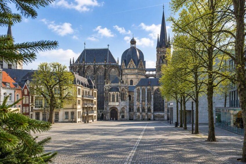 A historic church with a large dome and spire, surrounded by cobblestone streets and traditional buildings. 4