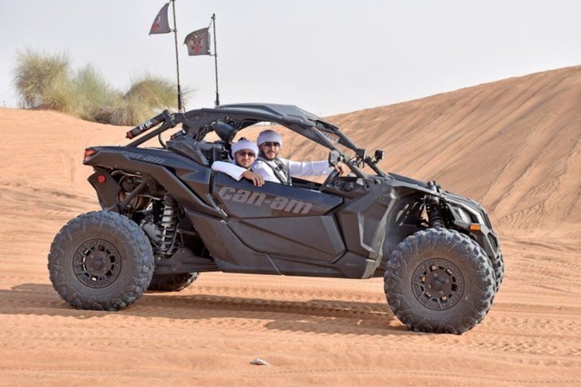A black off-road vehicle with a desert landscape in the background. 2