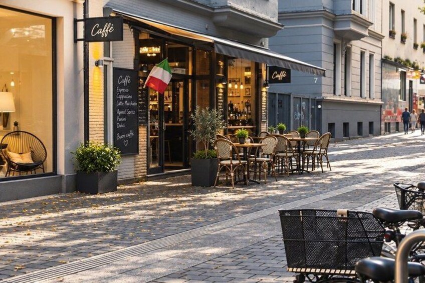 A café with outdoor seating, a signboard with the café's name, and a flag. 3