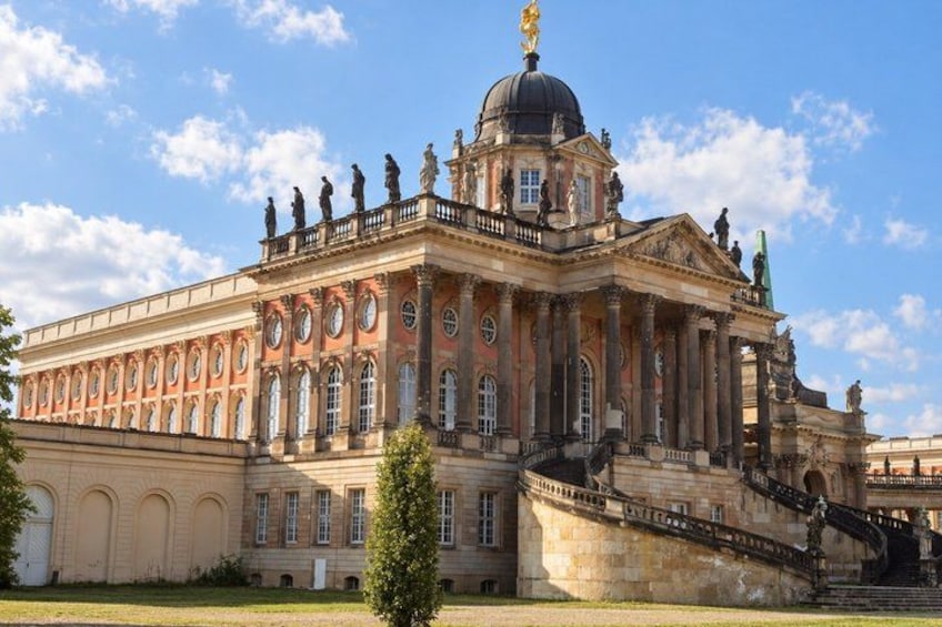A large classical building with a dome, columns, and statues. 5