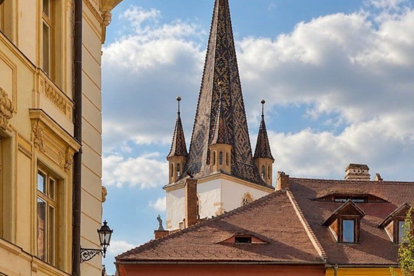 A church with a tall, pointed spire and a clock tower. 4