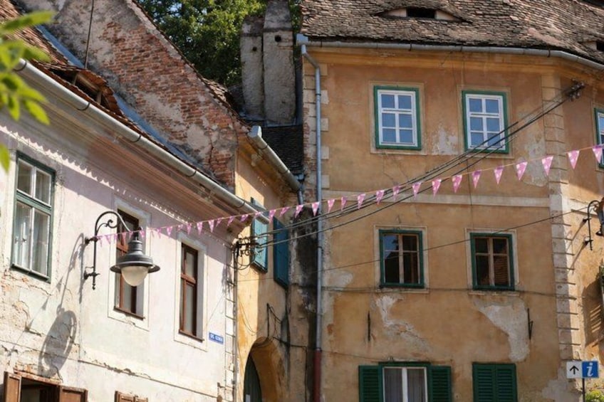 A street with buildings, a street lamp, and a sign with an arrow. 3