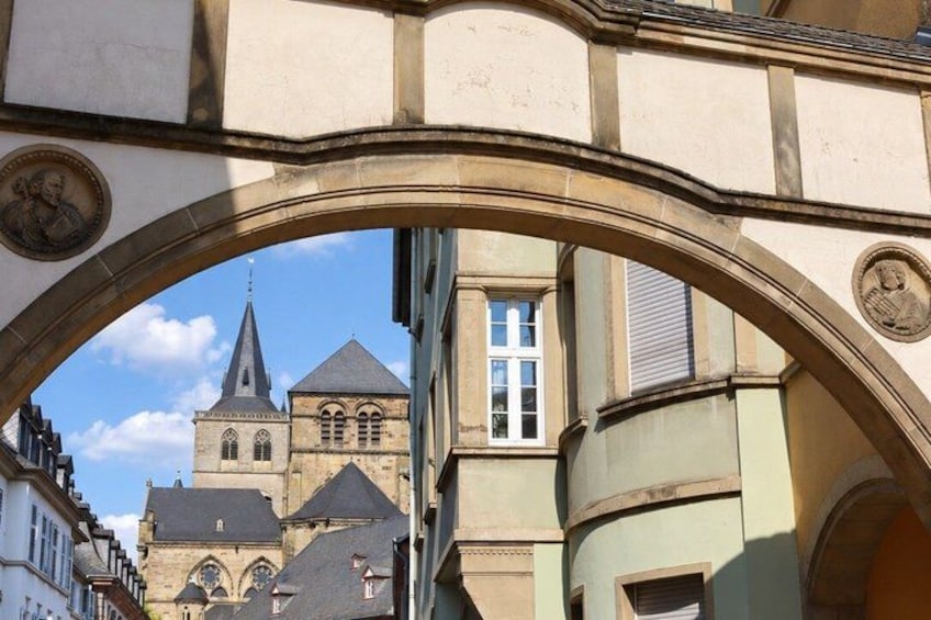 A stone archway with a church in the background. 3