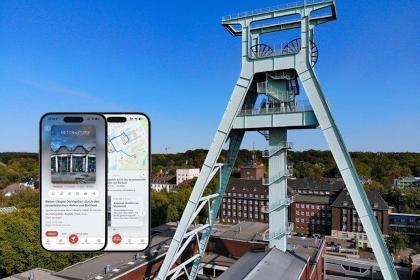 A tall, light blue structure with a viewing platform, surrounded by buildings and greenery. 1