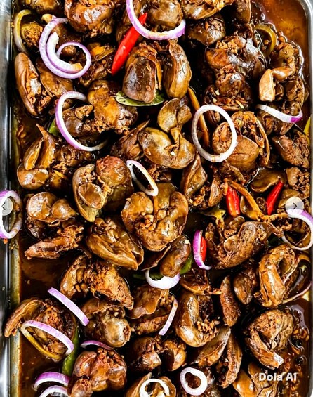 A tray of cooked crabs garnished with sliced onions and red chili peppers. 4