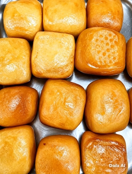 A tray of square-shaped, golden-brown baked goods. 5