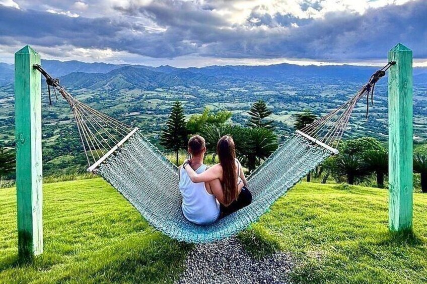 A hammock between two wooden posts overlooking a mountainous landscape. 2