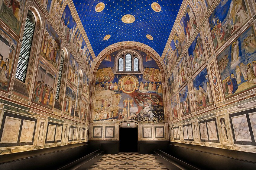 An ornate church interior with detailed frescoes, a starry ceiling, and a central altar. 4