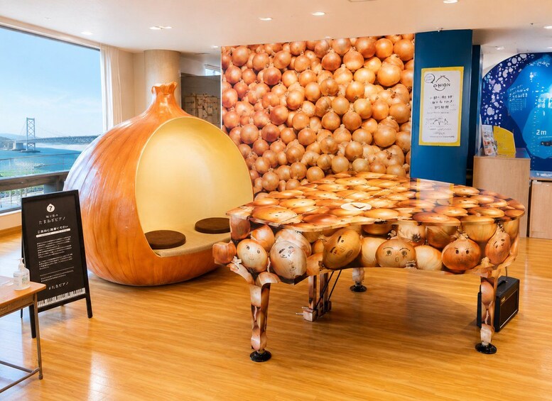 A unique table made of onions, a large onion sculpture, and a wall of onions. 3