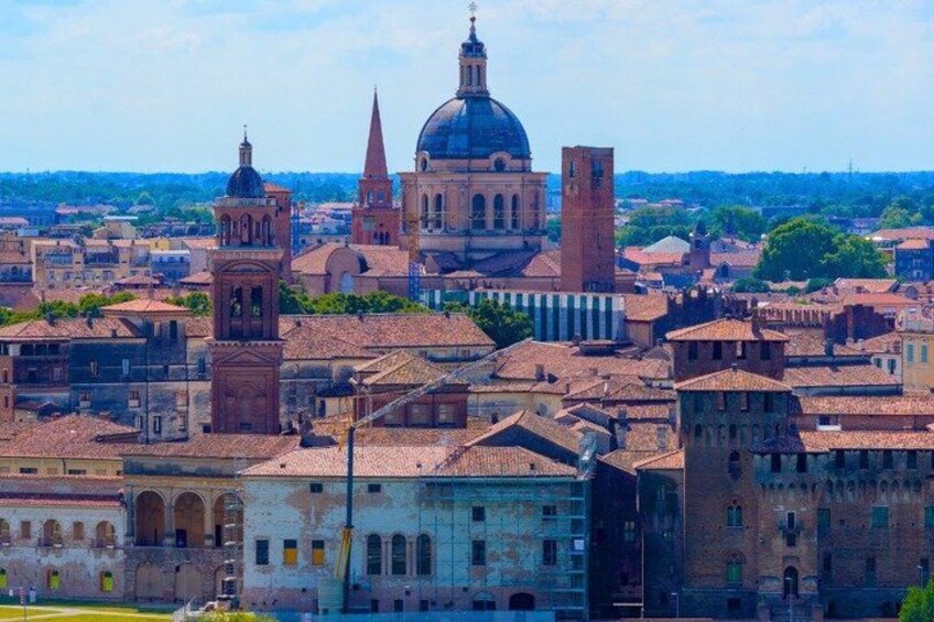 A cityscape with historic buildings, a prominent dome, and a tower. 4