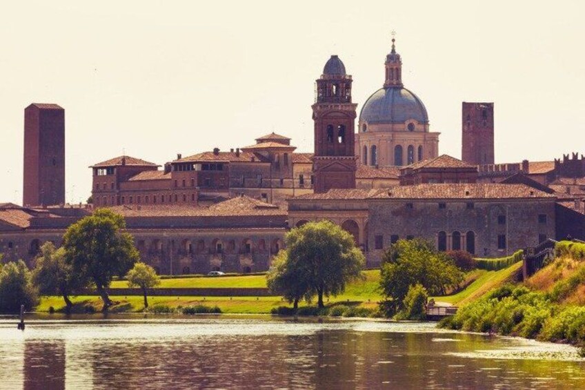 A historic building complex with a large dome, bell towers, and a river in the foreground. 5