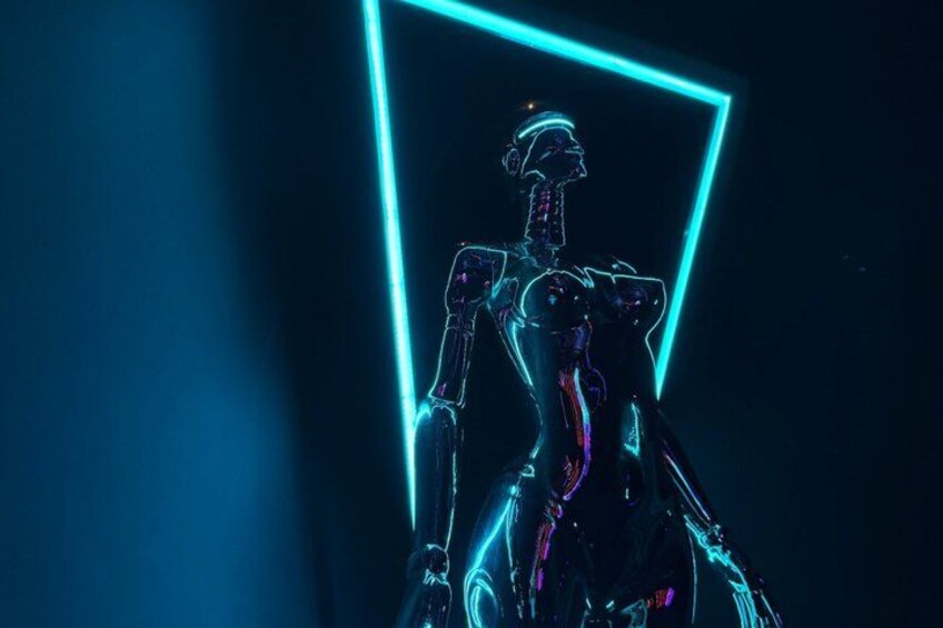 A humanoid robot with a glowing blue outline, standing in a dark environment. 3