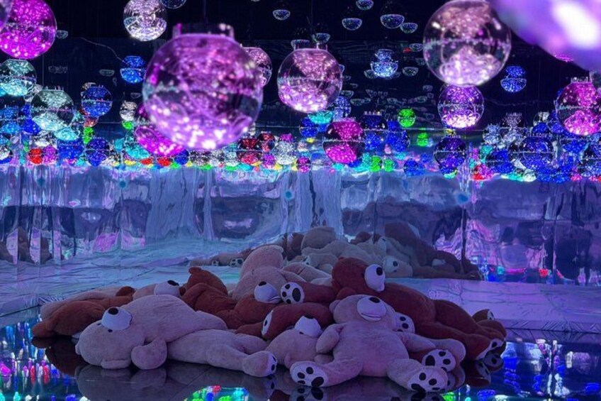 A reflective surface with plush toys and colorful hanging ornaments. 2