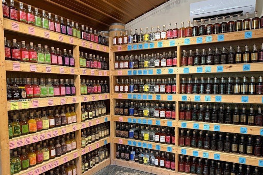 Shelves stocked with various bottles of alcohol, organized by type and brand. 3