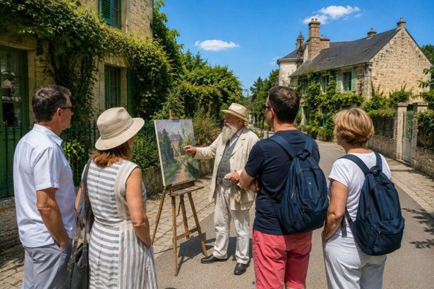 A group of people observing a painting outdoors, with stone buildings and greenery in the background. 3