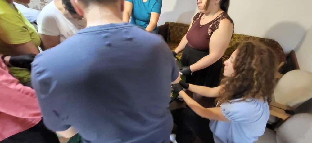A group of people sitting on a couch in a room. 1