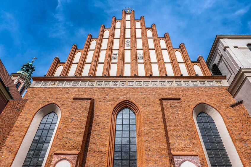A historic building with a prominent tower and arched windows. 5