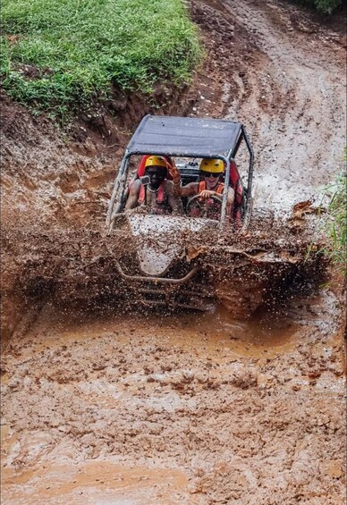 A vehicle navigating a muddy off-road trail. 3