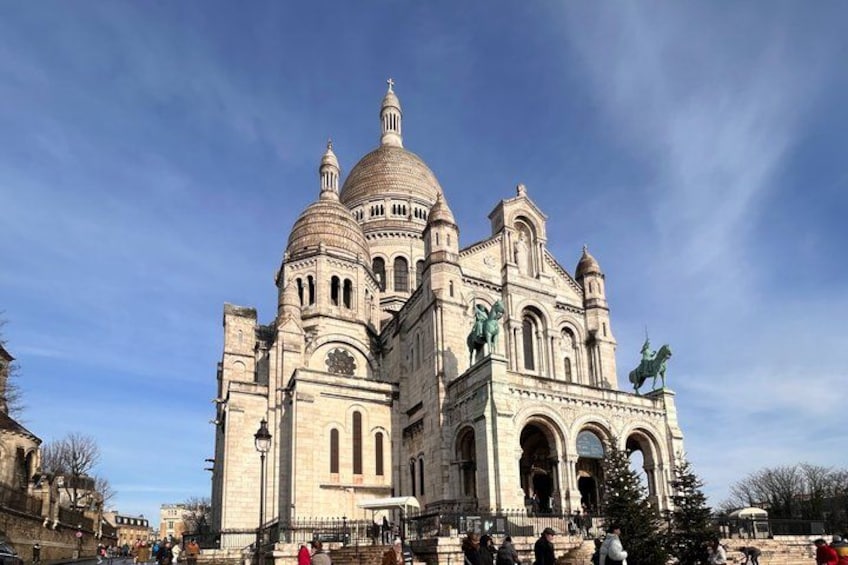 A large, historic building with multiple domes and a statue on the roof. 2