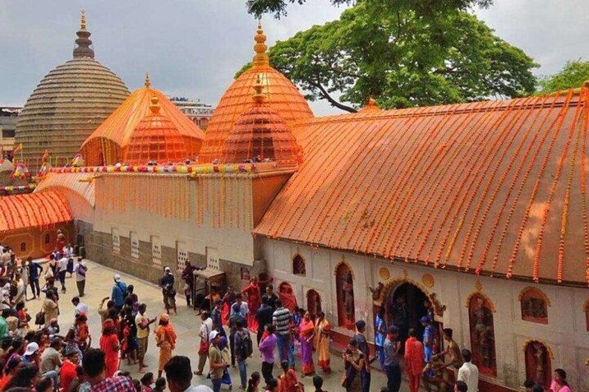 A temple complex with multiple domed structures and a crowd of people. 3