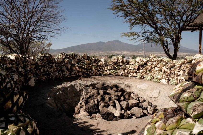 A stone wall, a dry riverbed, and a mountainous landscape. 2