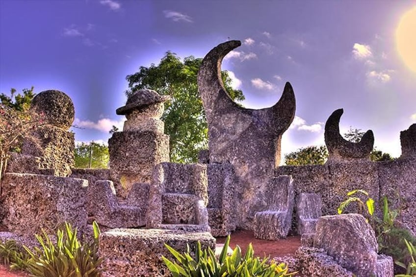 Ancient stone ruins with crescent-shaped structures and a clear sky. 1