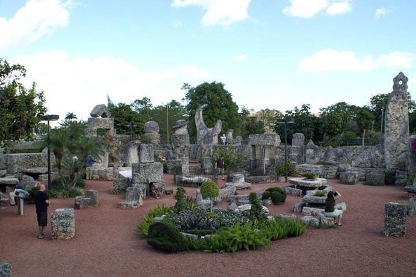 A cemetery with stone headstones and a central garden area. 3