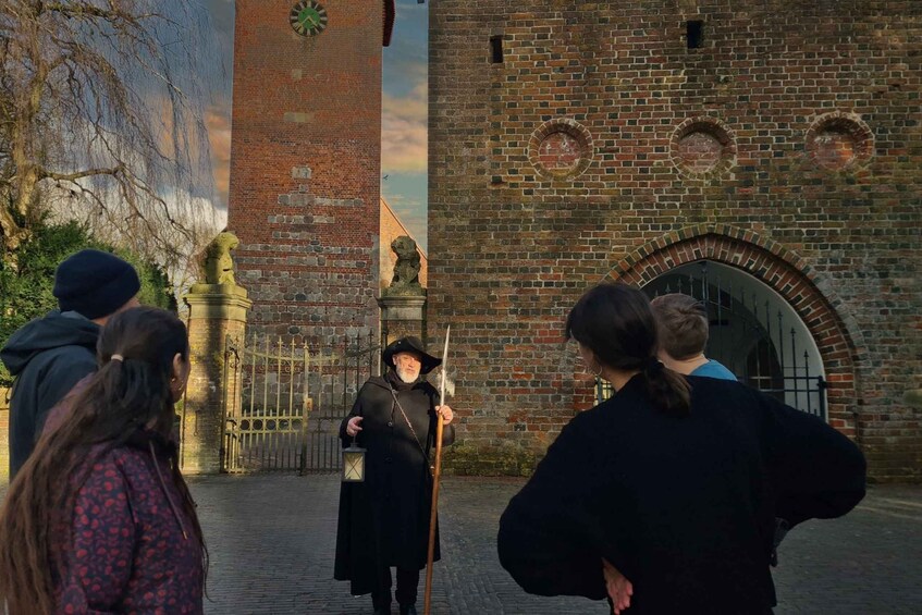 A historical building with a clock tower, a lion statue, and a person in period costume holding a sword. 5